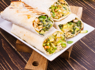 Chicken, avocado, cilantro and cheese burritos