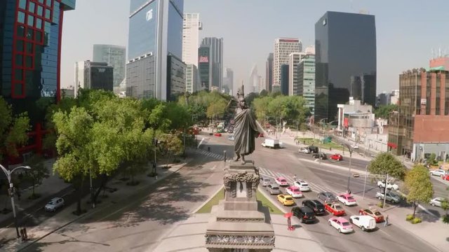 Aerial glides up the Cuauht&Igrave;&copy;moc statue on the Paseo de la Reforma in Mexico City.