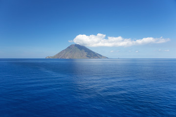 Isolated cloud above Stromboli Island. The volcano has erupted many times and is constantly active with minor eruptions. Mt. Stromboli has been in almost continuous eruption for the past 2,000 years.