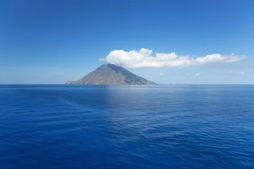 Tuinposter Isolated cloud above Stromboli Island. The volcano has erupted many times and is constantly active with minor eruptions. Mt. Stromboli has been in almost continuous eruption for the past 2,000 years. © Vermeulen-Perdaen