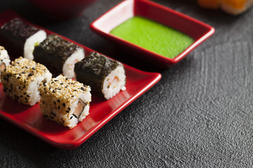 Sushi food on red plate and wasabi