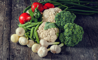 Mixed vegetables of cauliflower and broccoli, garlic, green onions, tomatoes and green peas.
