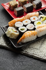 Traditional japanese cuisine - sushi set on black table