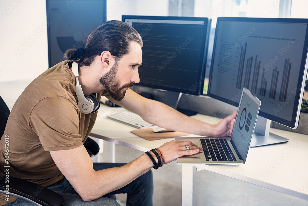 Poster serene employee having job on notebook computer