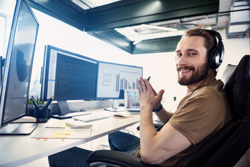 Fototapeta premium Cheerful bearded employee having job in office