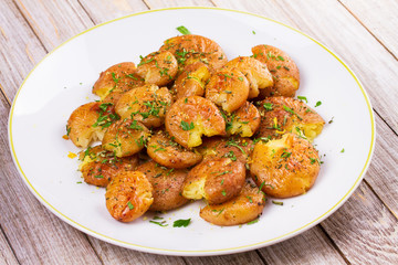 Smashed Potatoes with parsley, dried rosemary, lemon zest and yogurt sauce