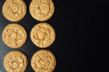 Biscuit sweet cookie background. Domestic stacked butter biscuit pattern concept,close up macro.Homemade cookies on wooden table.Cereal biscuits with the sesame,peanuts,sunflower and amaranth.