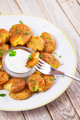 Smashed Potatoes with parsley, dried rosemary, lemon zest and yogurt sauce