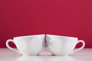 Two white cups on a red background. I love uou.