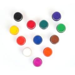 Acrylic colors on a white background in jars arranged in the form of a heart