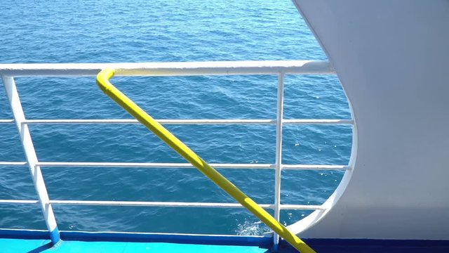 Looping background of a moving ship with blue Sea behind the white railing, easy to set as a side plate for travel clips or vacation videos