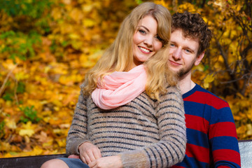 Fototapeta premium Lovers couple in autumn park on bench