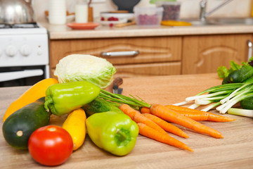 fresh fruits and vegetables on the table in kitchen interior, healthy food concept