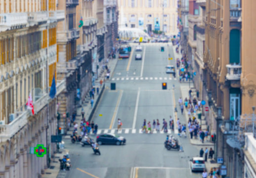 Blurred image of people and traffic moving in crowded city street. Art toning abstract urban background. Crowd of traffic anonymous people walking on busy city street.