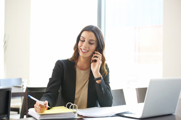 Confident young businesswoman portrait. Shot of a young financial professional woman making call...