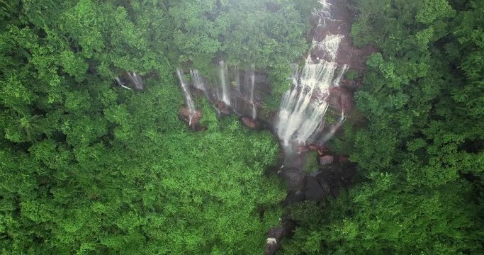 4K aerial view of waterfall in THAILAND. Nakhonphanom. Shooting from the drone fly over the rain forest and natural stream from waterfall