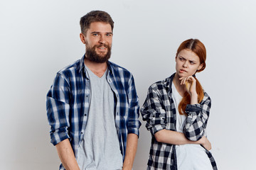 Young beautiful woman and guy with a beard on white isolated background, repair, construction tools