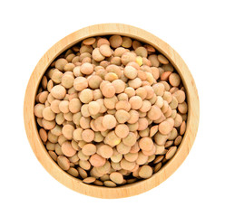 lentils in wood spoon isolated on white background