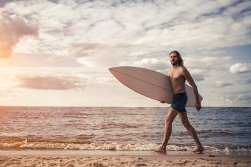 Fototapeta na wymiar Young man with surfboard