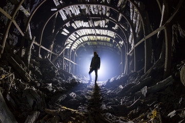 Silhouette of a man in an abandoned tunnel