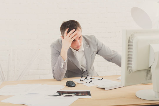 Young businessman in office with computer