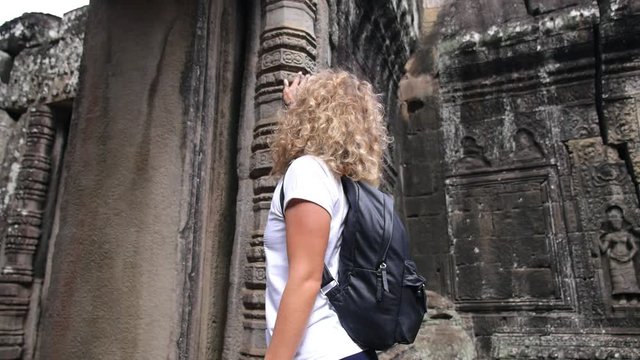 Beautiful Woman Tourist Sightseeing In Ancient Angkor Wat Temple. HD, 1920x1080. Siem Reap. 