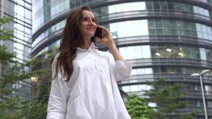 Happy businesswoman talking on phone