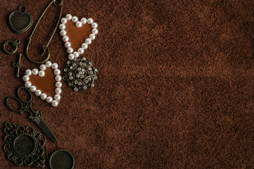 Vintage accessories and decorations on a background of brown suede