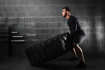 crossfit training - man flipping tire