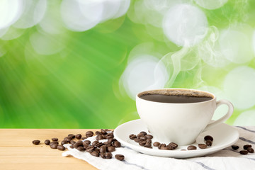 Coffee cup on wood table and green natural background., With copy space.