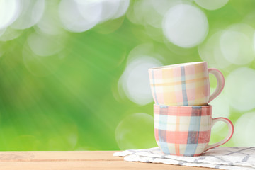Coffee cup on wood table and green natural background., With copy space.