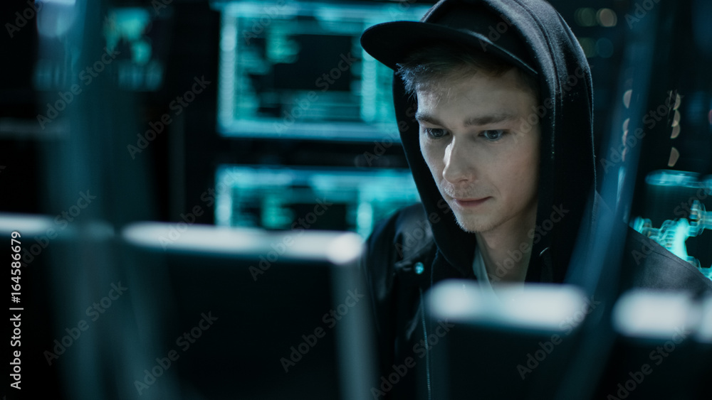 Poster hooded teenage hacker successfully attacks global infrastructure servers with virus.