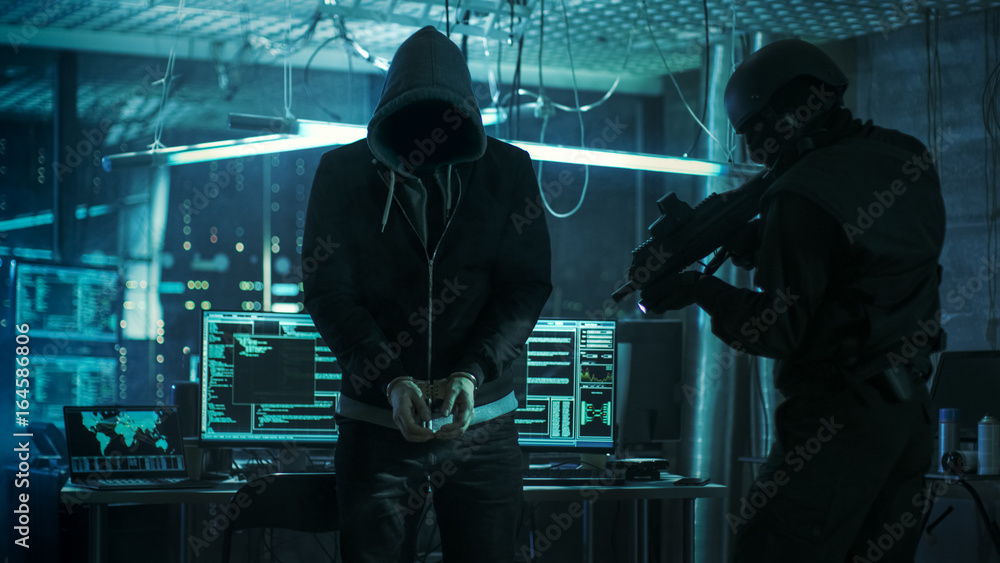 Aufkleber Handcuffed Masked Hacker is Standing and Guarded by Fully Armed Special Forces Soldier. They're in Hacker's Hideout Basement with Multiple Operating Displays.