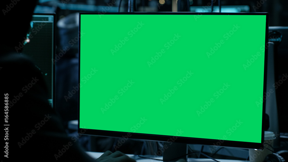 Poster display with green screen in hackers den.