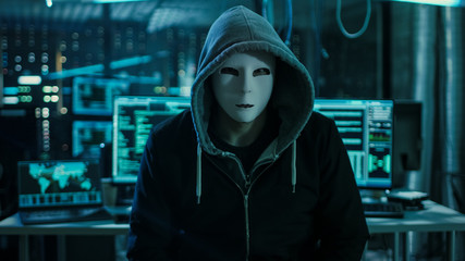 Dangerous Internationally Wanted Hacker with Covered Face Looking into the Camera. In the...