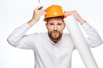 Engineer with a beard on a white isolated background holds blueprints