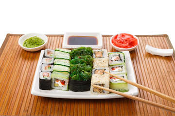 Set of sushi, maki and rolls on bamboo mat