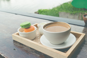 hot coffee breakfast set with fresh macaroon in outdoor bakery house cafe(vintage)