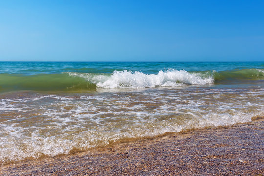 Black sea coast, seascape with sand beach,small wave splash, azure water, blue sky, summer sea rest concept