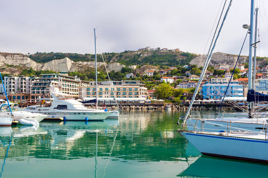 Yachts, sailing boats and pleasure boats are moored in marina of Balchik city in black sea coast at Bulgaria