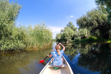 Fototapeta na wymiar Woman in Danube Delta by boat
