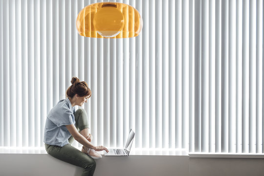 Woman using laptop at home
