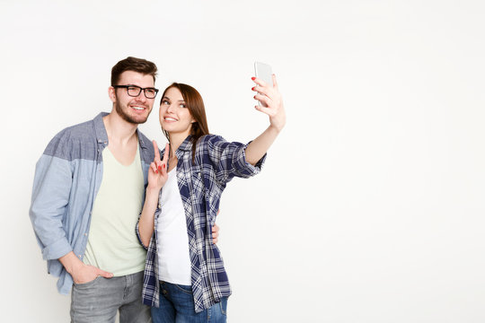 Happy Casual Couple Doing Selfie On Smartphone, Isolated