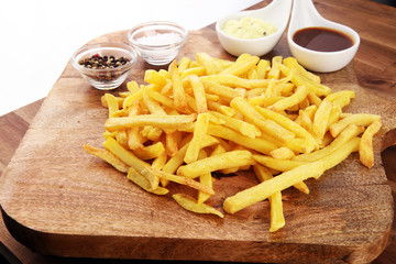 Close up Crispy Potato Fries with Two Dipping Sauce, Served on Rustic Wooden Table