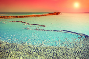 Naklejka na ściany i meble Dead sea salt shore at sunrise