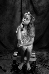 young girl posing in the studio in black & white 