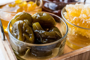 Fig Jam with spoon in glass bowl..
