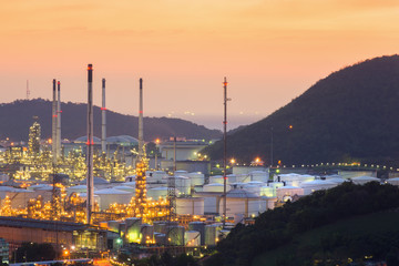 Oil refinery tanks and pipes at twilight