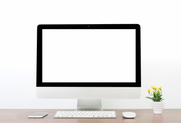Office monitor computer, mouse on wooden table and white wall background