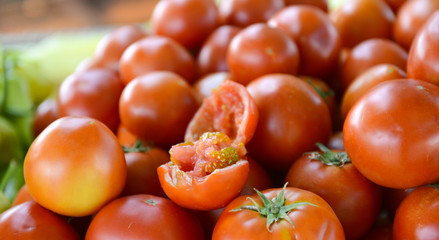 Fresh tomatoes for sale on a farmer market ,focus on a juicy chopped tomato, shallow dof